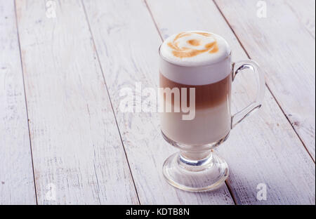 Delicious cappuccino on plank wooden table Stock Photo