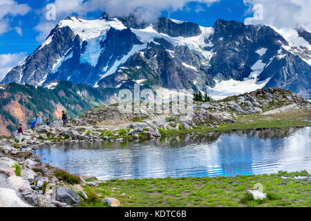 Hikers Mount Shuksan Pool Reflection Summer Artist Point Mount Baker Highway Pacific Northwest Washington State Snow Mountain Grass Trees Stock Photo