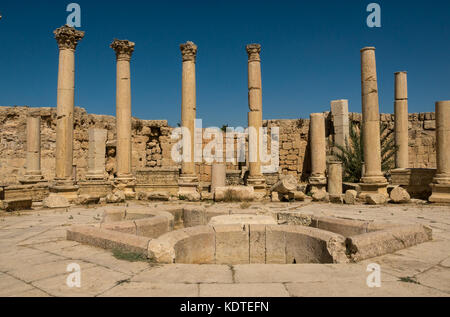 The Macellum, agora, or market, courtyard with cruciform fountain, Roman city of Jerash, archeological site in northern Jordan, Middle East Stock Photo