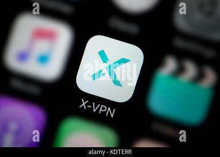 A close-up shot of the logo representing the X-VPN app icon, as seen on the screen of a smart phone (Editorial use only) Stock Photo