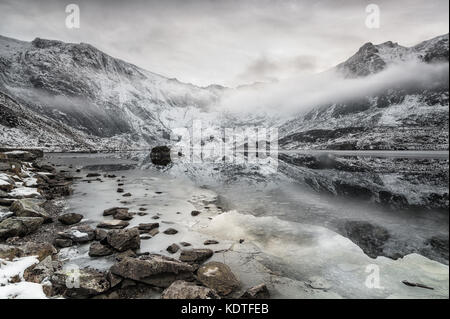 Llyn Idwal with frozen Lake and Low mist formed in Winter Time,  Ogwen, Wales, UK Stock Photo