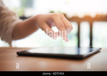 Close up of mans hands using tablet on counter Stock Photo
