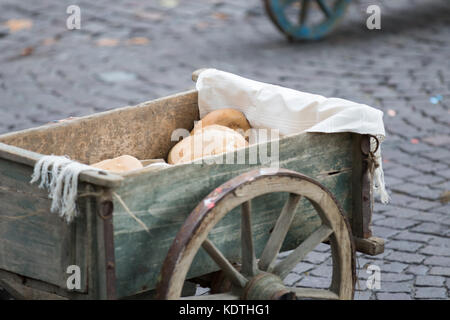 Asti, Italy - September 10, 2017: Loaf of bread transported in an old wooden cart Stock Photo