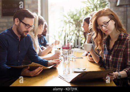 Happy colleagues from work socializing in restaurant Stock Photo