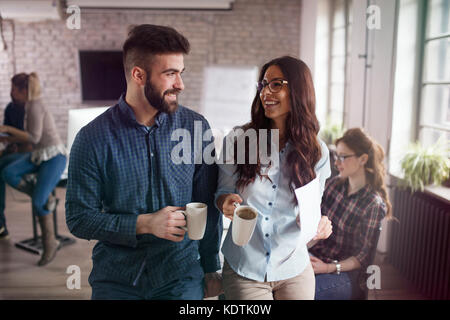 Picture of young designers discussing in office Stock Photo