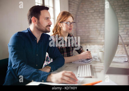 Portrait of young designers working on computer Stock Photo