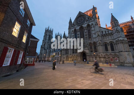 Evening in York centre  - south entrance to magnificent York Minster taken from the piazza where people walk & cycle - North Yorkshire, England, UK. Stock Photo
