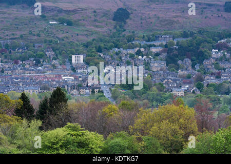 Evening view over residential buildings & high street, nestling in Wharfe Valley under moorland - Ilkley town centre, West Yorkshire, England, UK. Stock Photo