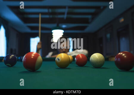 Young caucasian man playing billiards ready to shoot. Stock Photo