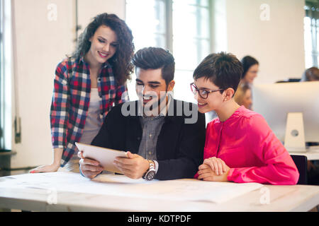 Group of young architects using digital tablet Stock Photo