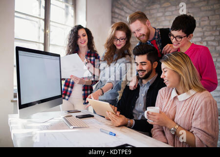 Group of young architects using digital tablet Stock Photo