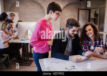 Group of young architects looking at digital tablet Stock Photo