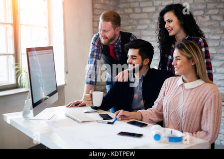 Group of young architects working on computer Stock Photo