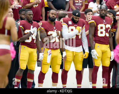 Washington Redskins players stand at attention as the National Anthem is played prior to the game against the San Francisco 49ers at FedEx Field in Landover, Maryland on Sunday, October 15, 2017. From left to right: former center Jeff Bostic; running back Mack Brown (34); running back Samaje Perine (32); tight end Niles Paul (84) and wide receiver Brian Quick (83). Credit: Ron Sachs/CNP - NO WIRE SERVICE - Photo: Ron Sachs/Consolidated News Photos/Ron Sachs - CNP Stock Photo