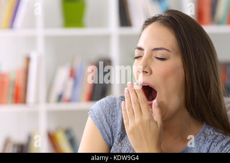 Tired lady yawning in a house interior Stock Photo