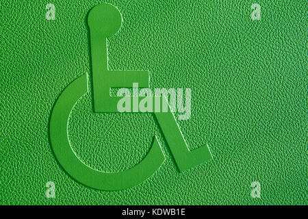 Disabled symbol on a green textured background. Horizontal Stock Photo