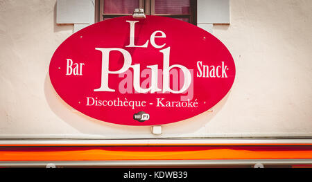 NOIRMOUTIER, FRANCE - July 03, 2017 : sign of a pub in the city center where it is written in French - the pub disco karaoke Stock Photo