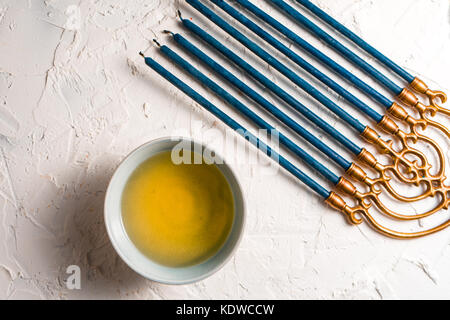 Fragment of Hanukkah with blue candles and butter in a bowl diagonal horizontal Stock Photo