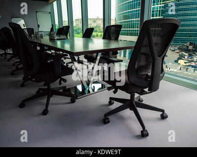 Empty conference room overlooking downtown district, shallow depth of field Stock Photo