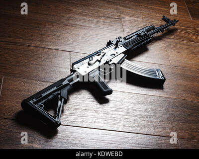 Custom build Kalashnikov assault rifle AKM on wooden floor Stock Photo