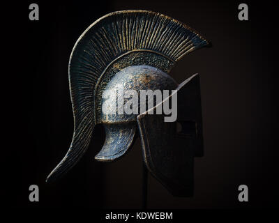 Ancient greek Sparta type helmet in Low Key. Display model. Stock Photo