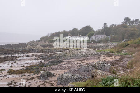 View taken across the beach at Rockcliffe, Dumfries and Galloway in Scotland, with mist and rain. Stock Photo