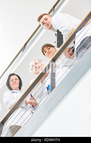 Team of doctors at hospital working together in cooperation Stock Photo