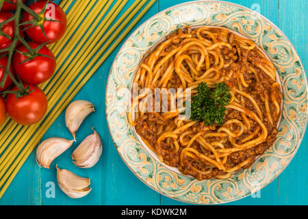 Italian Style Spaghetti Bolognese Meal  With a Rich Beef Sauce On A Blue Wooden Background Stock Photo
