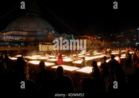 NEPAL. KATHMANDU — MAY 03, 2017 : The offering of burning oil lamps near the stupa  Bouddanath in Kathmandu. Kathmandu is the capital and the largest  Stock Photo