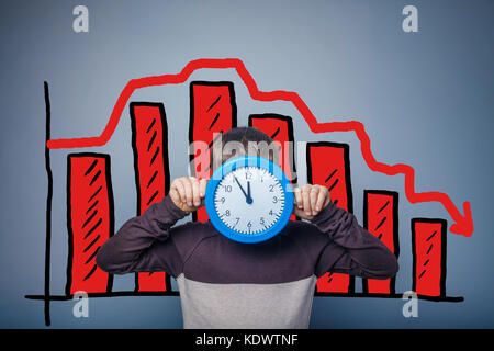 boy covered his face with clock businessman chart crisis decline Stock Photo