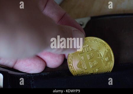Bitcoin replica in a wallet Stock Photo