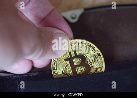 Bitcoin being put into wallet Stock Photo