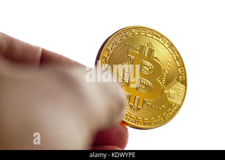 Man putting replica bitcoin into a wallet Stock Photo