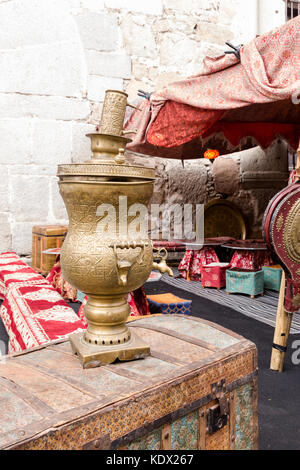 Arab old brass kettle over an old travel trunk Stock Photo