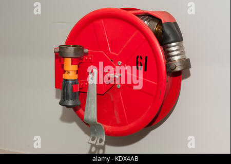 Fire hose reel on a container ship Stock Photo