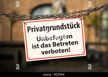 Warning sign with german text 'Privatgrundstueck - Unbefugten ist das Betreten verboten' ( private property - no trespassing) Stock Photo