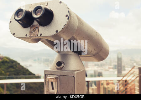 Tourist telescope for Hong Kong city observation from Victoria Peak viewpoint, vintage tonal correction, retro filter effect Stock Photo