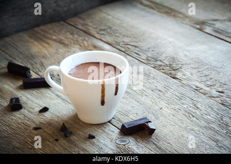 Hot Chocolate and chocolate pieces over rustic wooden background. Homemade Hot Chocolate Drink for Christmas and winter holidays. Stock Photo