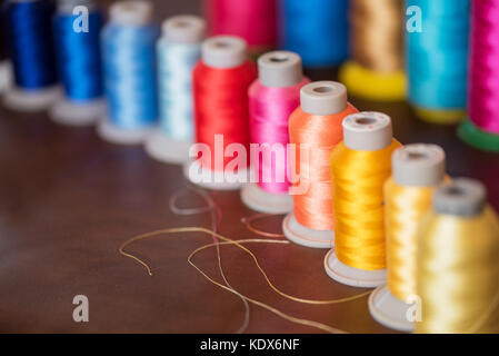 Colorful cotton yarns on rolls for sewing. Thread spools used in fabric and  textile industry Stock Photo - Alamy
