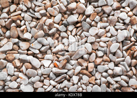 Natural abstract pebbles background, top view of surface covered with small stones Stock Photo