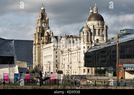 Liverpool, UK. The Port of Liverpool Building at Pier Head, with part of the new RIBA North building, and the Royal Liver Building in the background Stock Photo