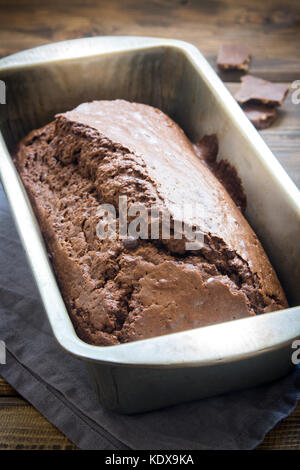 Chocolate Pound Cake with Rum and Chocolate Drops in baking dish. Homemade dark chocolate pastry for breakfast or dessert. Stock Photo