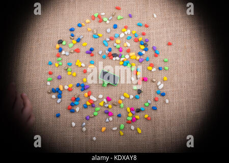 Little noticeboard amid Colorful pebbles spread on canvas Stock Photo