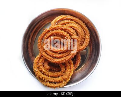 Chakali or murukku or chakri is diwali festival cutural snack serve as refreshment snacks for guest.this is selective focus shot from above. Stock Photo