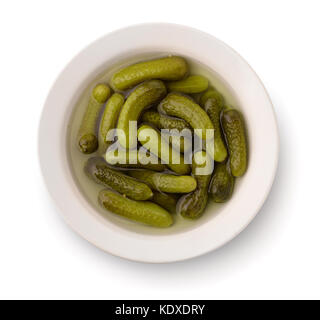Top view of pickled cucumbers in bowl isolated on white Stock Photo