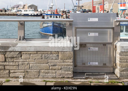 glass floodwall and flood gate - Kirkwall Harbour Flood Defence Scheme, Kirkwall, Orkney, Scotland, UK Stock Photo