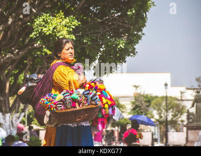 SAN MIGUEL DE ALLENDE, GUANAJUATO / MEXICO - 06 27 2017: Mexican indigenous woman with traditional dress selling dolls Stock Photo