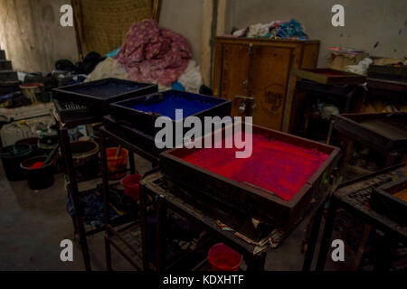 JAIPUR, INDIA - SEPTEMBER 19, 2017: Close up of a wooden square with assorted colors of painting, used for for Textile in India. Block Printing Traditional Process in Jaipur India. Center of Traditional Handicrafts of India Stock Photo