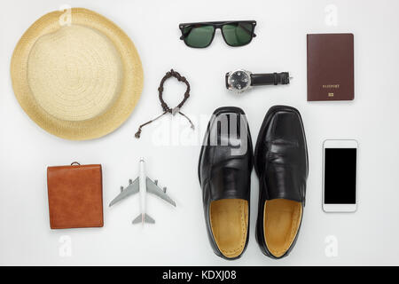 Flat lay of accessories travel and fashion men concept background.Essential items for trip on the white wooden at home office desk.Variety objects for Stock Photo