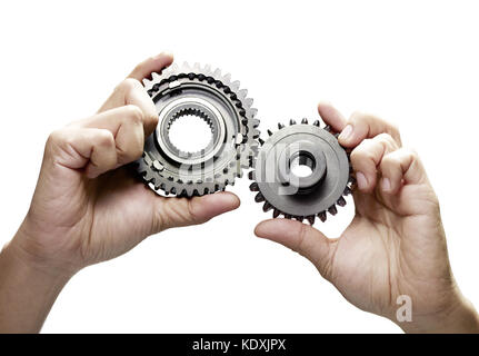 hands connecting gears on a white background Stock Photo